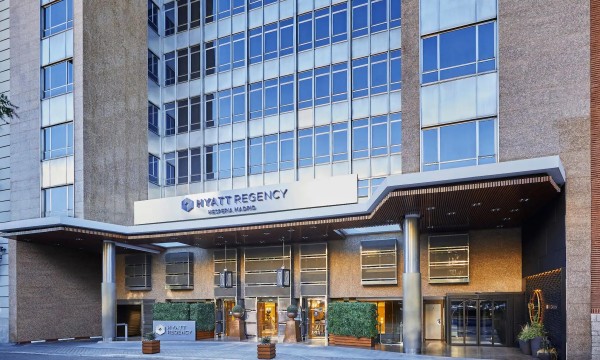 Hyatt Regency Hesperia Madrid hotel entrance with modern architecture and landscaping in the foreground.