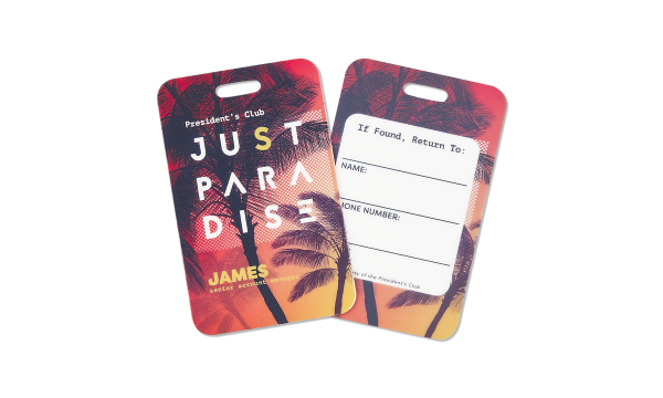Front and back of name tag with the words Just Paradise and a tropical sunset.