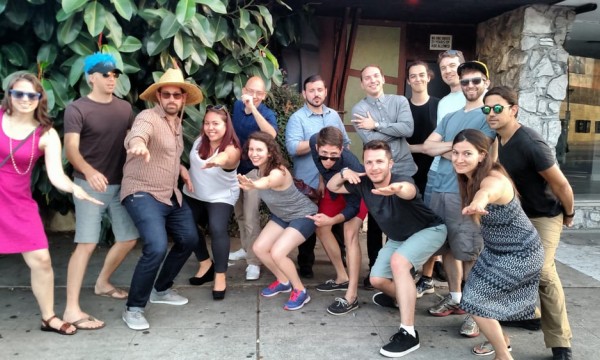 A group of people posing for a photo in front of the Mystery Trip entrance.