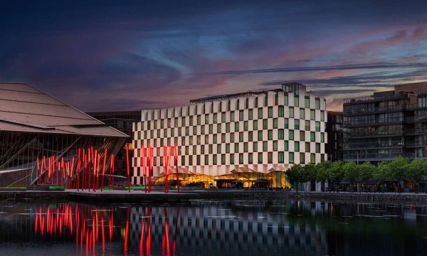 Anantara The Marker Dublin hotel exterior in Ireland with a body of water in front.
