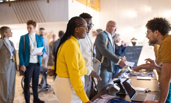 People at a conference discussing the hospitality manager's guide to booking software.