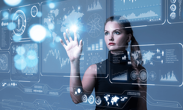 A person interacts with a futuristic touchscreen interface displaying data visualizations, maps, and charts in a tech-driven environment.