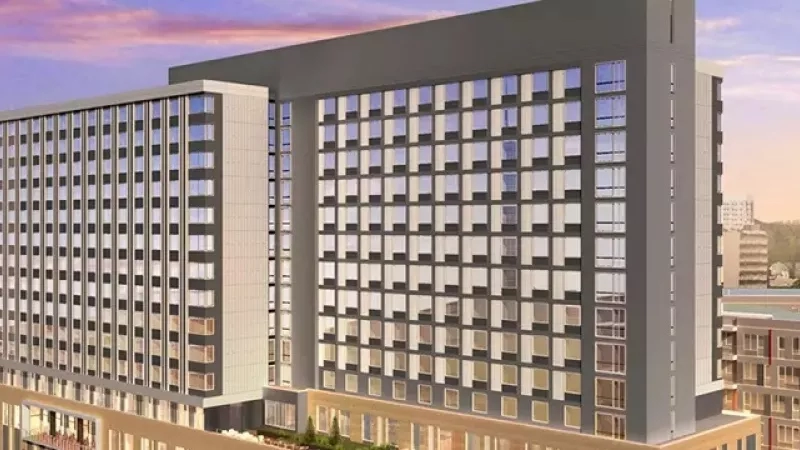 Hyatt Regency Portland, a tall building with many windows and a city view with other buildings and trees.