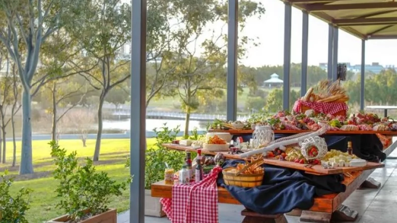 The outdoor dining area of the Waterview restaurant, showcasing a dining table filled with food and a scenic view.