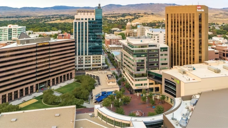 Cvent Blog Feature 4: A vibrant cityscape with diverse architecture, greenery, and a central plaza under a clear sky.
