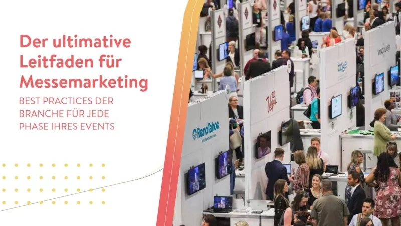 A group of people are in a room with banners, text, and monitors for an event.