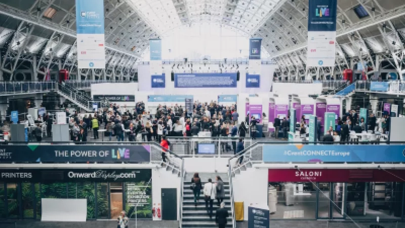 People gathered at an event at a mall with signs that read "The Power of Live" and "Saloni".