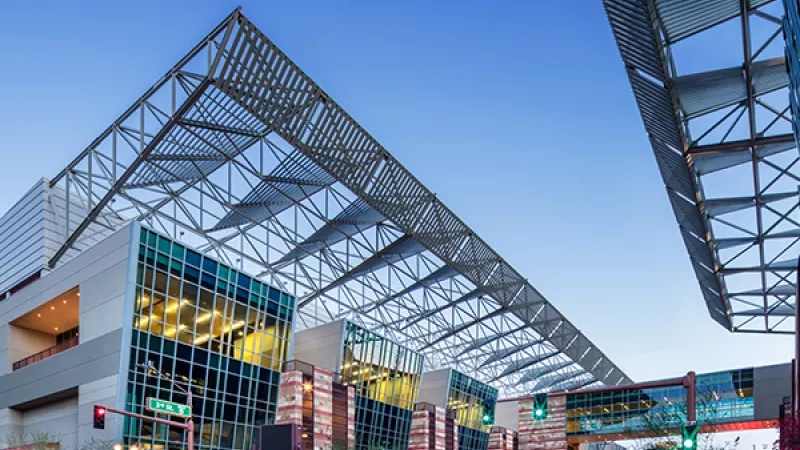 Phoenix Convention Center building with a canopy and a bridge under a blue sky in Arizona.