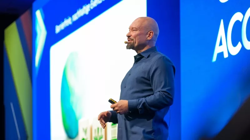 Markus Laibacher speaks at a Cvent Accelerate event in front of a screen that says AC.