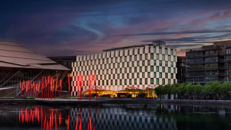 Anantara The Marker Dublin hotel exterior in Ireland with a body of water in front.