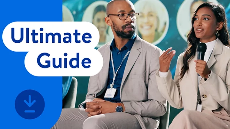Two speakers engaged in a discussion on stage