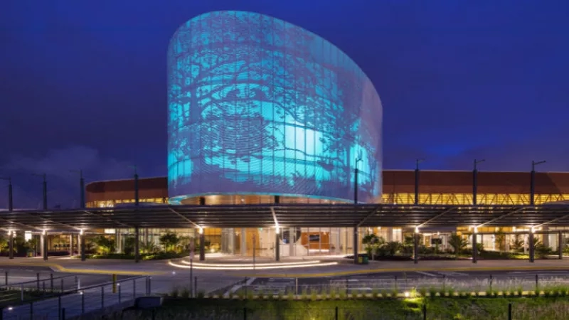 Exterior of the Panama Pacifico International Airport at night with the blue lighted sculpture.