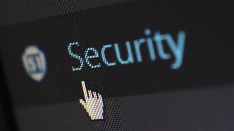 A screen showing the word security in blue with a hand cursor pointing at it.