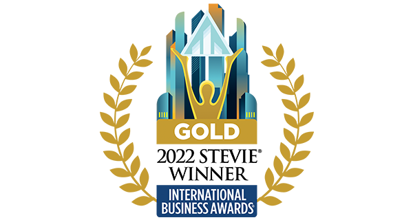 Gold winner for virtual event, a person holding a pyramid, and a city in the background.