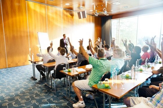 Many people are attending a meeting in a conference room at the Hotel Villa Honegg in Switzerland.