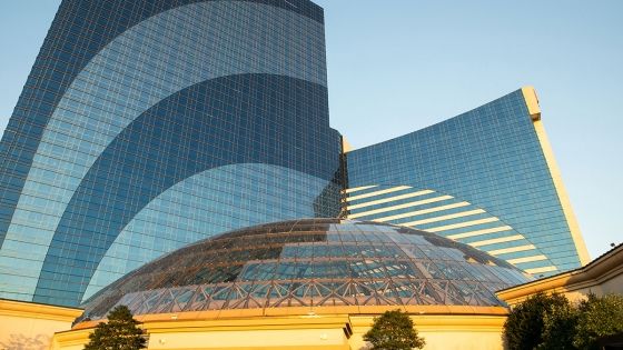 Glass exterior of the Borgata Hotel Casino & Spa in Atlantic City with the blue sky in the background.