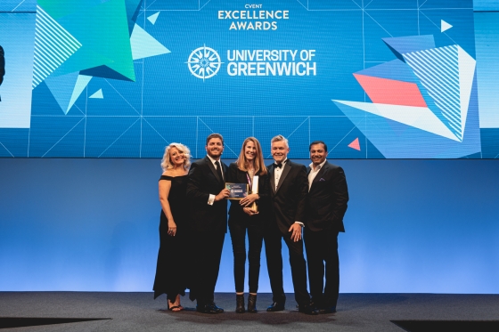Group of five people standing on stage holding an award for CVENT Excellence Awards at University of Greenwich.