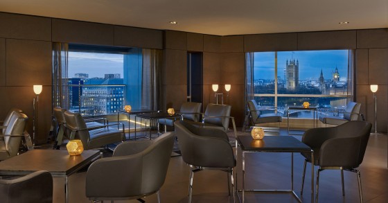 The executive lounge of Park Plaza Westminster Bridge London with a view of Big Ben at dusk.