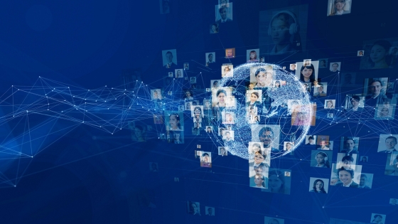 A network of globes with faces inside on a blue background with a wireframe net in front.