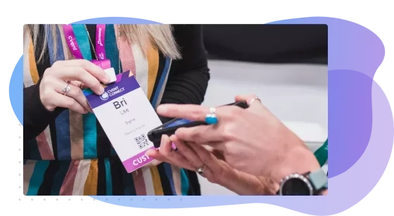 An attendee scans her badge at an event with a mobile device.
