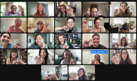 Multiple people are holding bottles of perfume in a video call on a screen that says "Ask to Unmute."