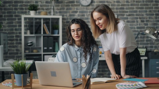 Two women looking at data on a computer
