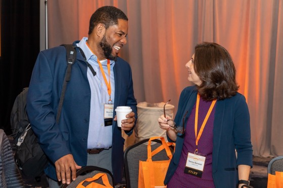 Man and woman talking at A View from All Sides conference