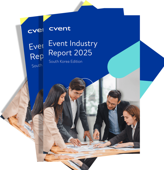 Two copies of the "Event Industry Report 2025" for South Korea, displayed on a table with people discussing details.