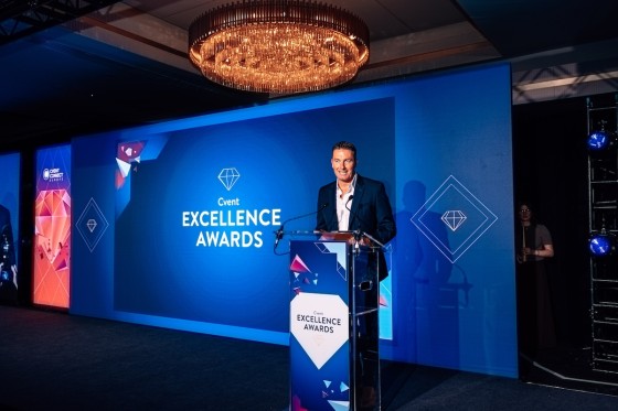 Man presenting on stage at the Cvent Excellence Awards