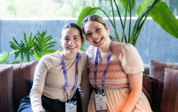 Two young women smiling and posing for a photo at Event Connect at the Aria Resort and Casino.